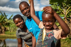 Young Mopao shows off one of the fingerlings found swimming in the fish farms of South Sudan.